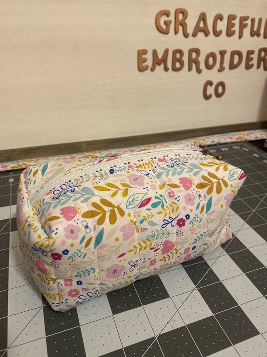 Floral-patterned fabric on a cutting mat with 'Graceful Embroidery Co' branding.
