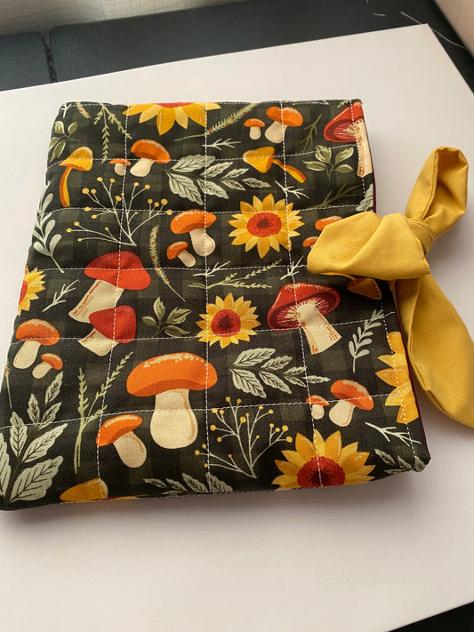 Fabric pouch with floral and mushroom pattern on a white background